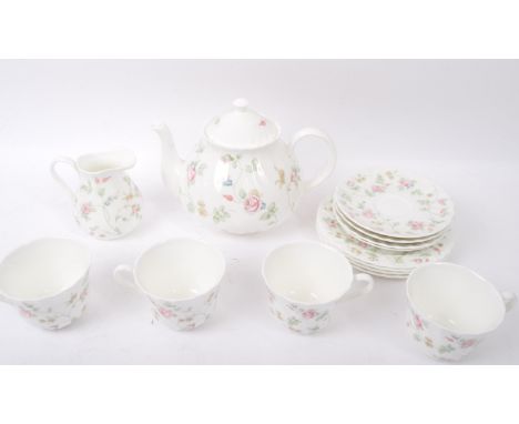 A vintage 20th Century Wedgwood fine bone china English tea service set in Rosehip pattern. Comprising of four person set, cu