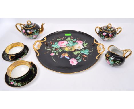 A 19th century French porcelain cabaret trayed tea set for two. The cabaret set comprising of teapot, lidded sugar bow, milk 