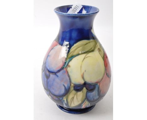 Moorcroft pottery - English designer - 20th Century ceramic pottery on Hibiscus pattern. Small form tapering body with hand p
