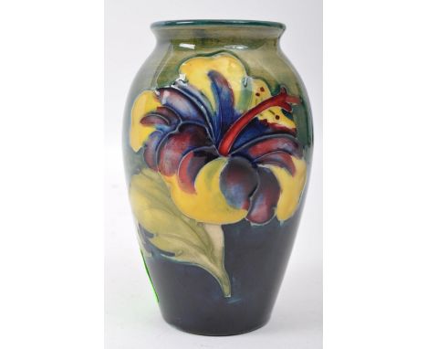 Moorcroft green pottery - English / British design - 20th Century ceramic pottery hibiscus pattern. Small form tapering body 