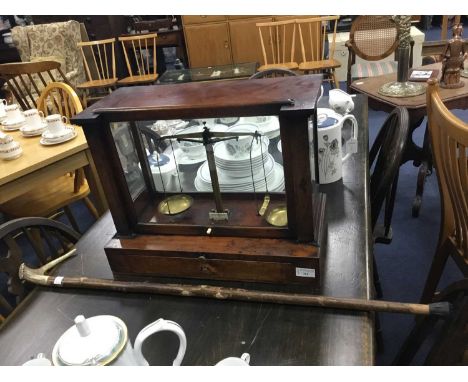 SET OF 20TH CENTURY BRASS SCALES,in a wood display case, along with a walking stick (2)