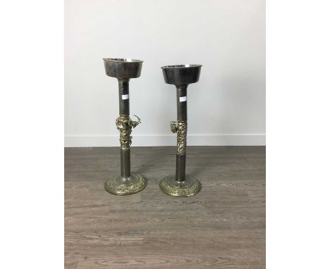 NEAR PAIR OF EAST ASIAN DRAGON PEDESTALS,early-mid 20th century, silvered metal with gilt highlights, the columns with centra