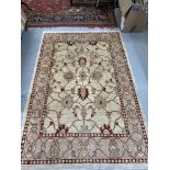 Modern weave rug, ivory colour highlighted with reds, blues and green. 81ins. x 58ins.