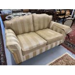 20th cent. Upholstered three-seater sofa, turned supports with cup and cover castors.