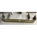 Two brass fire fenders, the larger 47ins. x 7½ins. The smaller 31½ins. x 6ins. Both with