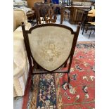 19th cent. Mahogany fire screen with needlepoint floral design within a shield.