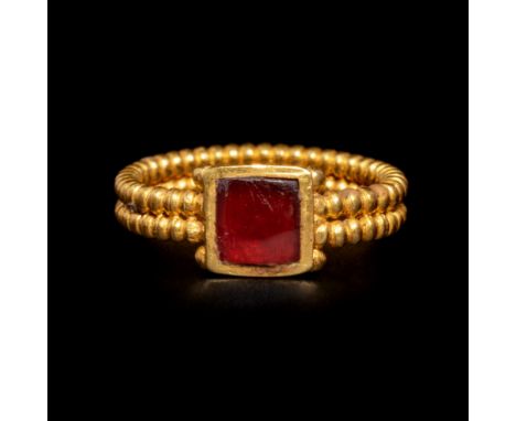 A Roman Gold and Garnet Finger Ring with CabochonCirca 3rd Century A.D.Ring size 3 1/3; Length of garnet 1/4 inch (0.5 cm).Pr