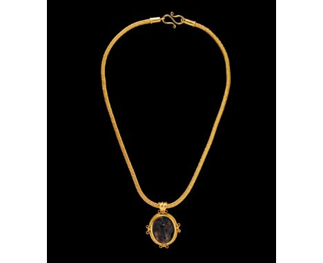 A Byzantine Gold Necklace with Molded Green Glass CameoCirca 5th-6th Century A.D. Length with chain 10 3/8 inches (26.5 cm); 