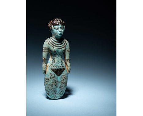 An Egyptian Faience Female FigureMiddle Kingdom, 12th Dynasty, 1991-1783 B.C.Height 5 1/8 inches (13.02 cm).Property from a P