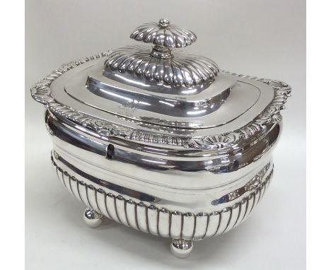 A Georgian silver half fluted tea caddy on ball feet with crested front. London 1811. By IW&amp;WE. Approx. 584 grams. Est. £