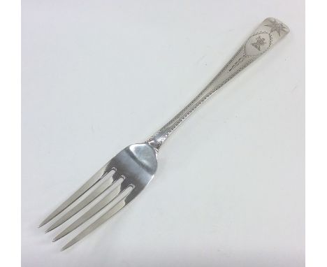 DUBLIN: An Irish Georgian silver bright cut fork. By JS. Approx. 25 cms long. Approx. 78 grams. Est. £80 - £120.