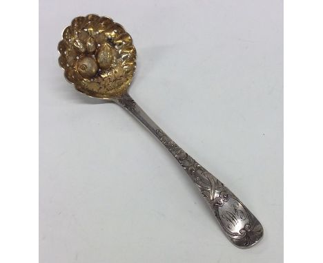 A good Georgian silver berry sugar ladle decorated with fruits. Approx. 40 grams. Est. £40 - £60.