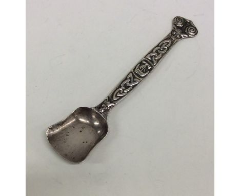 IONA: A large silver sugar scoop with tapering handle with Celtic decoration. Approx. 22 grams. Est. £65 - £75.