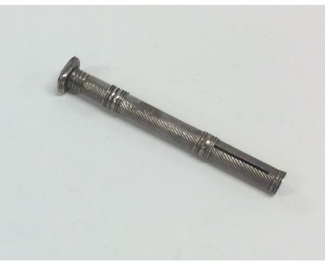 A silver engine turned extending pencil. Approx. 10.2 grams. Est. £10 - £20.