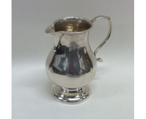 An early Georgian silver sparrow beak pitcher cream jug on circular tapering base. London. By TT. Approx. 101 grams. Est. £25