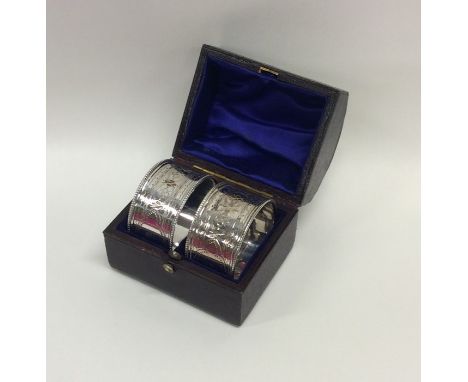 A pair of Victorian silver engine turned napkin rings. London. Approx. 48 grams. Est. £50 - £80.