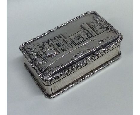 A good Georgian silver snuff box attractively decorated with a cathedral in relief and scroll border. Birmingham. By Perry. A