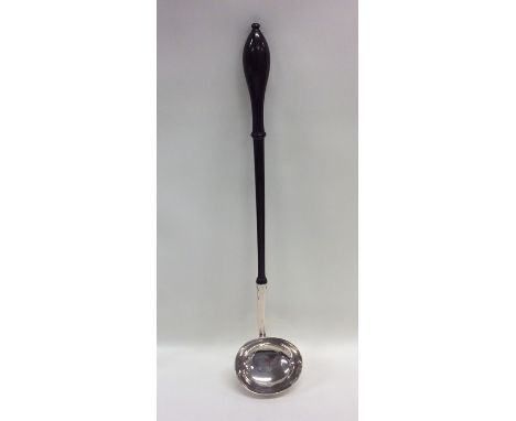 A good Georgian silver toddy ladle with turned wooden handle. London. By IP. Approx. 90 grams. Est. £150 - £200.