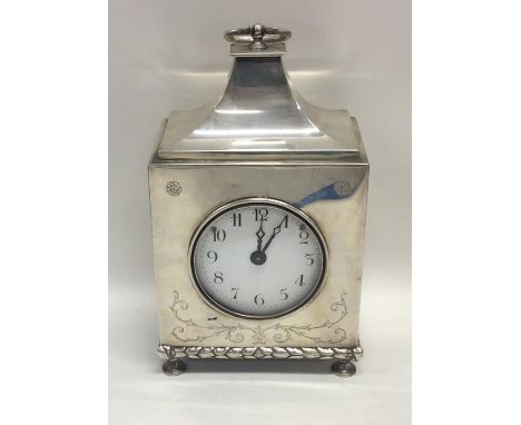 A large silver mantle clock with sweeping top to white enamelled dial engraved with scrolls. London. By C&amp;R. Approx. 1038