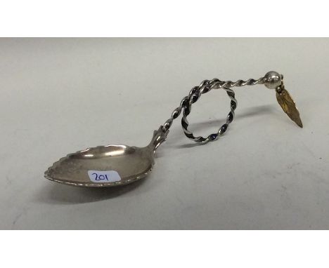 A Continental silver caddy spoon with swirl decoration. Approx. 21 grams. Est. £15 - £20.