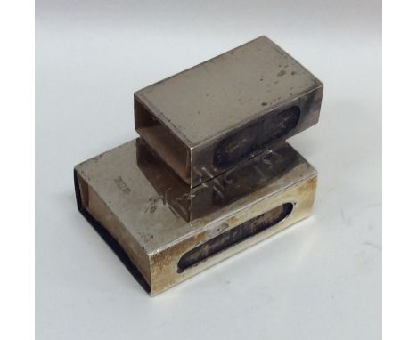 An engine turned silver match case together with one other. Approx. 43 grams. Est. £20 - £30.