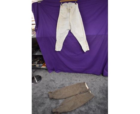 A vintage set of gents knee britches in beige wool, and a set of white polo or similar jodhpurs, button fly to both, early ar