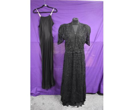 A black lace 1930s dress having separate blouse which sits slightly looser over the plain topped dress giving a two piece eff