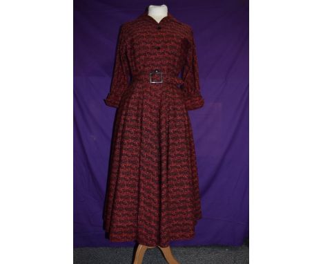 A 1950s Horrockses fashions day dress in red and black cotton having 3/4 sleeves, belted waist and incredibly full skirt, But