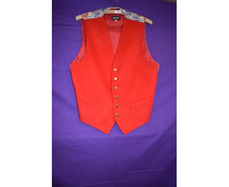 A pillar box red Liberty waistcoat having wool front and Liberty fabric to back.