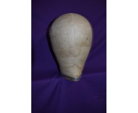 An early cloth covered wooden milliners head  or wig stand with metal band incised with '54'.