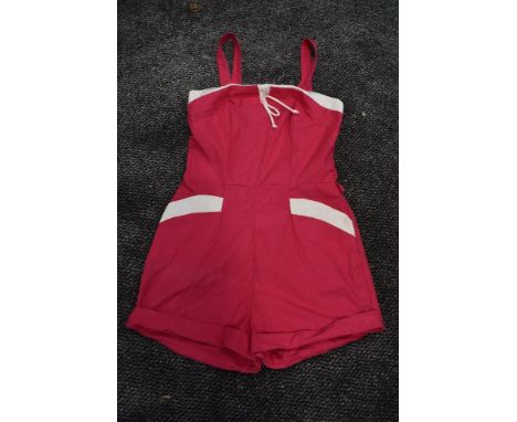 A 1950s Cerise and white cotton playsuit having pockets to front and button fastening to back.