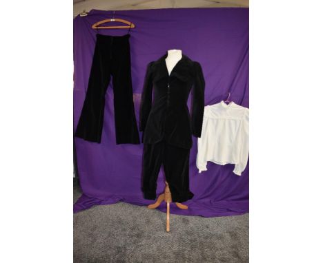 A dramatic black velvet late 1960s suit by Bus stop comprising of jacket with superb deco styling,breeches and a set of flare