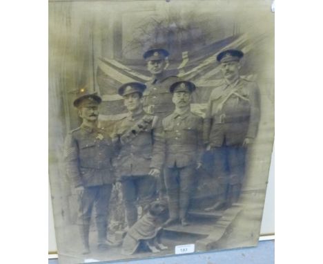 Black and white photographic print of five soldiers and their dog, in a glazed frame, 40 x 50cm 