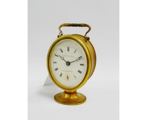 Small oval gilt brass timepiece, the enamel dial with Roman numerals and inscribed Thos Ellis, Plymouth, with swing handle to