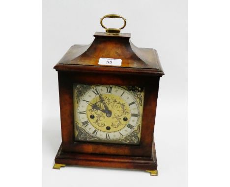 Burr walnut cased bracket clock, the brass dial with silvered chapter ring with Roman numerals and cherub embossed spandrels,