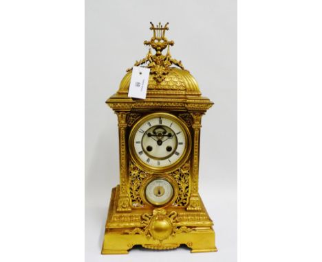 A large gilt brass table clock, the domed top surmounted by floral garlands above  the enamel chapter ring with Roman numeral