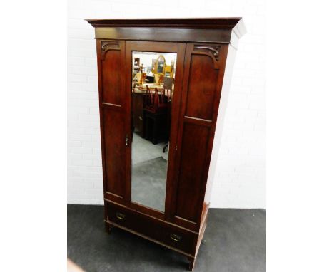 Mahogany wardrobe with a cornice top over a central mirror door over a long drawer tot he base, 192 x 102cm 