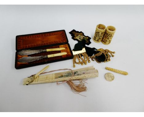 Mixed lot to include a cased set of Victorian Epns butter knives, a Masonic gilt metal epaulette, a canton carved bone needle