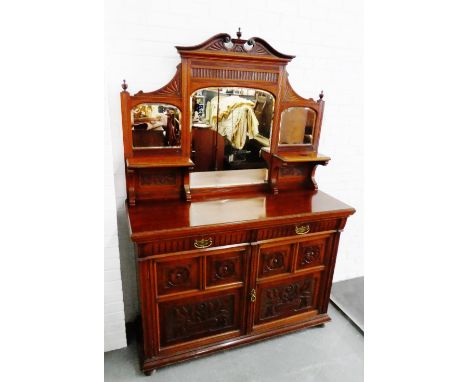 Mahogany dresser with broken swan neck pediment above a mirror back, over two long drawers and a pair of carved cupboard door