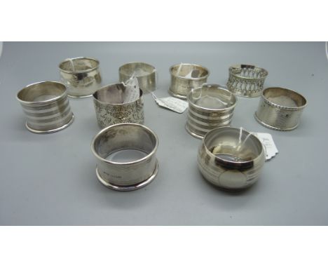 Eight silver napkin rings; two pairs with blank cartouches, hallmarks for Docker &amp; Burn, Birmingham 1922 and Haseler &amp