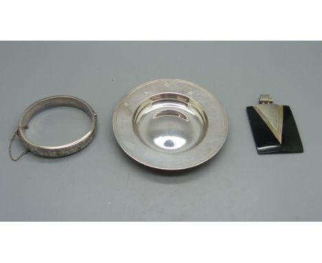 A silver bangle and a silver dish, 79g, and a silver mounted pendant 