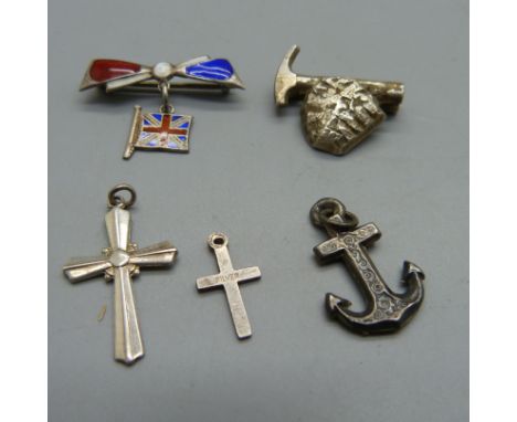 A Shetland silver mining brooch, a silver and enamel brooch, two small silver crosses and an anchor charm 