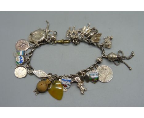 A silver charm bracelet with a WWI period silver John Bull charm set with a portrait of a gentleman in military uniform, meta