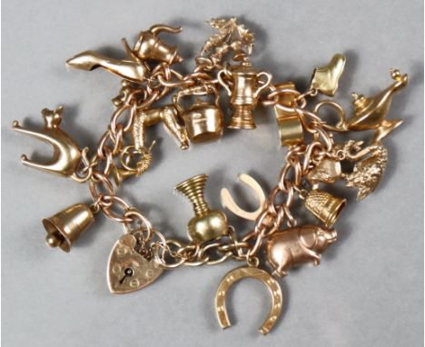 A 9ct. gold curb link bracelet with 19 pendant charms, &amp; padlock clasp with safety chain; the French horn with foreign ma