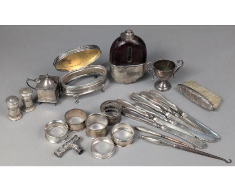 A pocket spirit flask with silver removable cup base (lacking lid); six various silver napkin rings; four small condiments; a