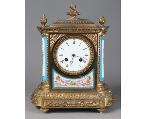 A 19th century French gilt-brass mantel clock inset Sevres-style porcelain panels to the front &amp; rounded sides, with 9cm 