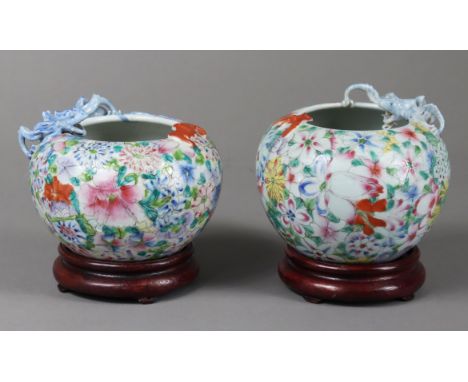 A matched pair of late 19th/early 20th century Chinese porcelain ‘millefleur’ squat round vases painted in famille rose ename