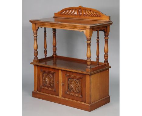 A late Victorian walnut small two-tier dumb waiter, with an open gallery above a cupboard enclosed by pair of carved panel do