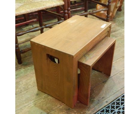 An Ercol style nest of four tables, with handle holds to the sides , 51 x 30 cms approx .