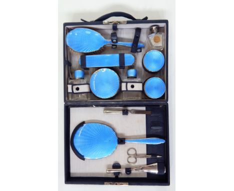 Black leather fitted dressing case containing blue guilloche enamel dressing set including hand mirror, brush, clothes brush,